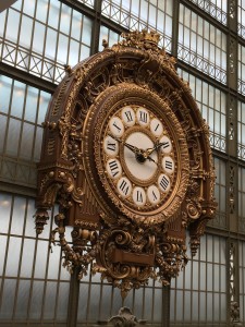 Large, ornate gold and white clock in Musee d'Orsay Paris France