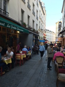 photo of small street in Paris lined with small cafes