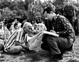 King Bhumibol speaking with people on a rural visit