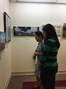 a mother and daughter viewing an art exhibit