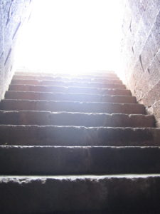 Photo of diffuse bright light at the top of stone staircase 