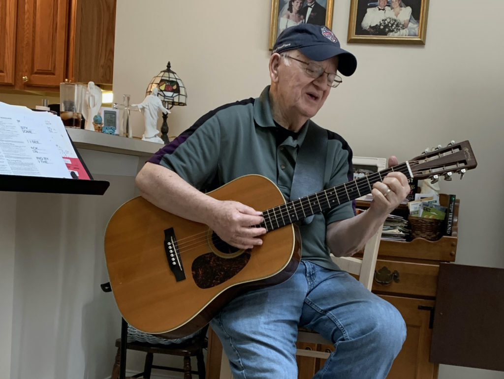 Mike Wood playing guitar and singing